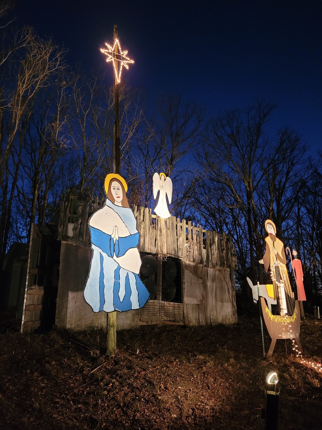 It's almost night when the lights come on at the Community Betterment Association's hilltop Nativity scene in Meta.